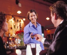 Customer handing credit card to waitress